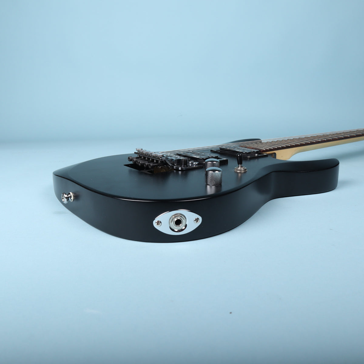Side view of the lower bout showing the chrome football-style output jack plate.