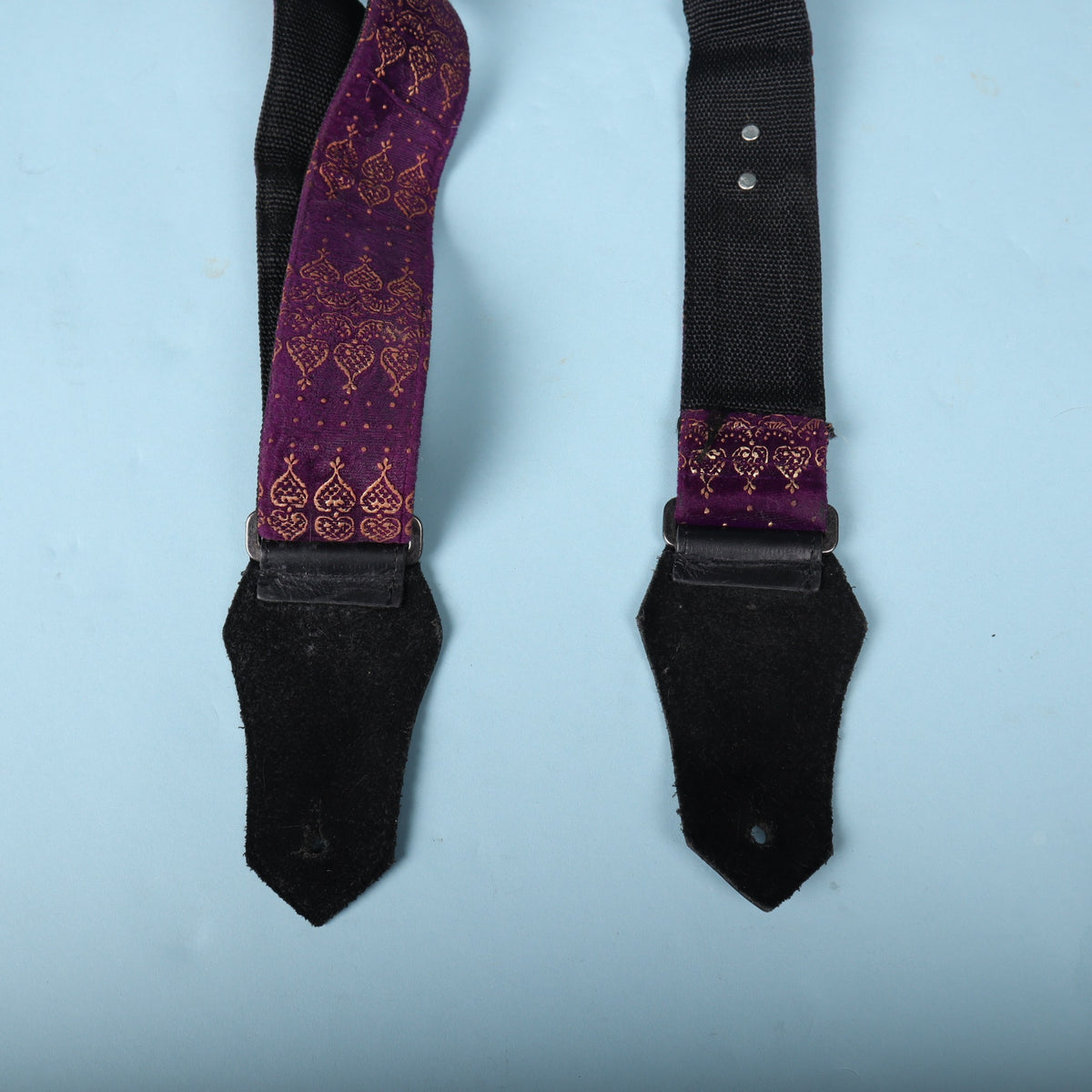 Backside of the black leather end tabs with buttonholes