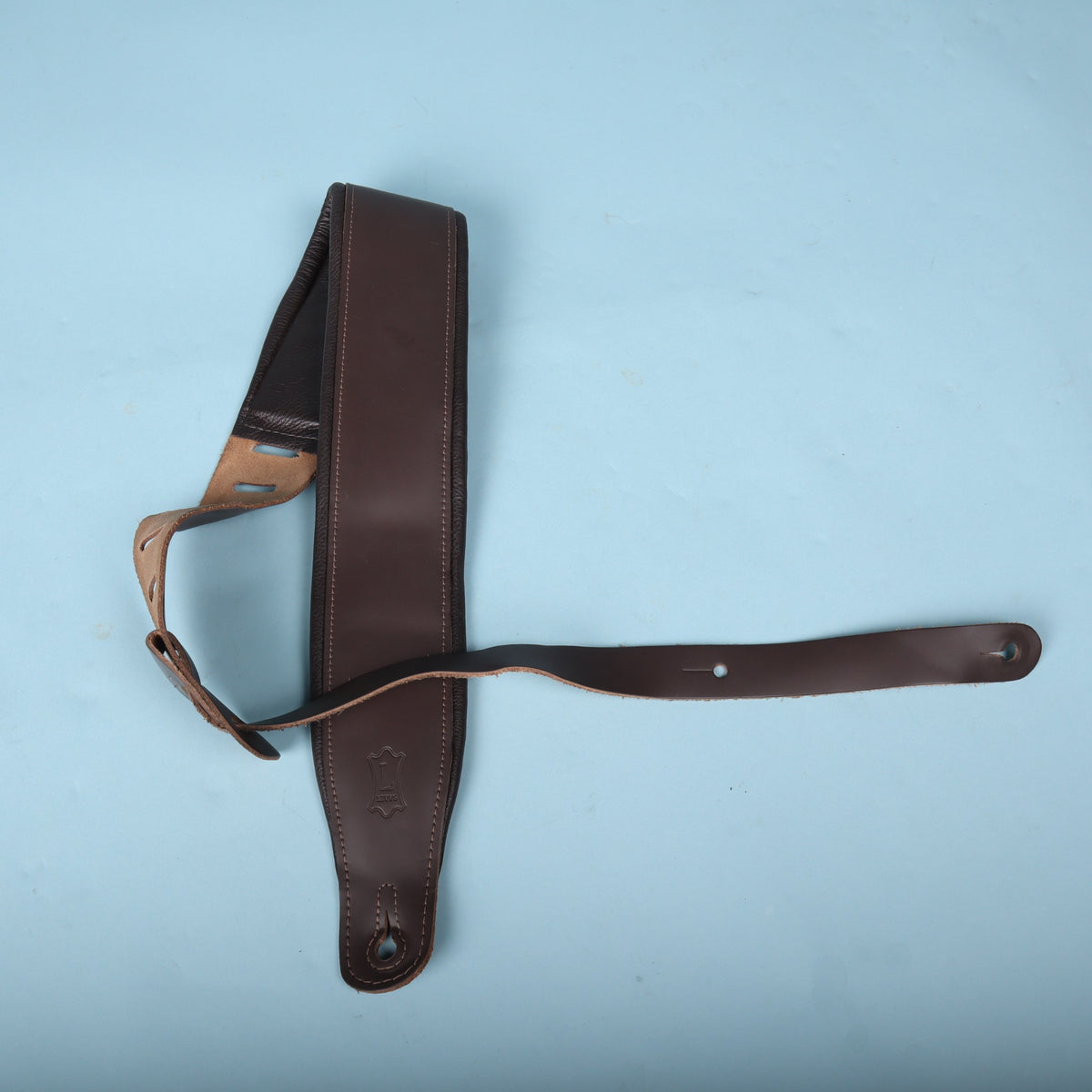 Levy's 3-inch padded leather bass strap laid out against a light blue background