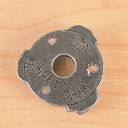 Close-up of the reverse side of the Gunther guitar plate displaying the stamped GUENTER mark.