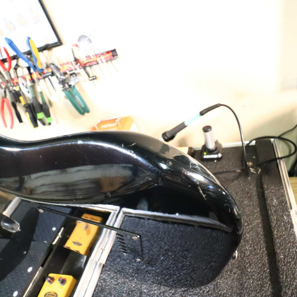 Close-up of upper bout edge showing finish wear and surface scuffs.