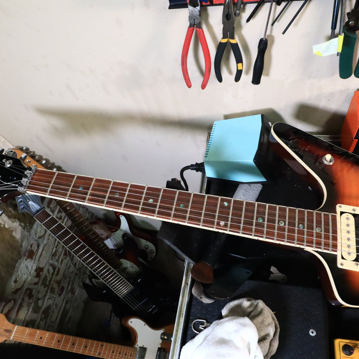 Dean ML fretboard and neck viewed on tech workbench