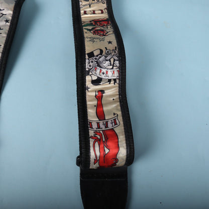 Close-up of the red devil pin-up and banner illustration near the leather tab