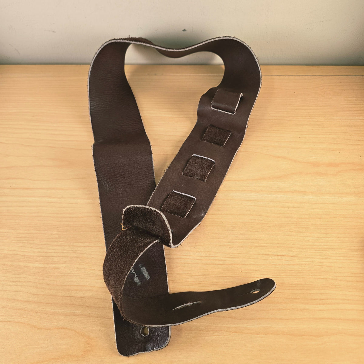 Full view of the Ernie Ball strap threaded through the adjustment slots