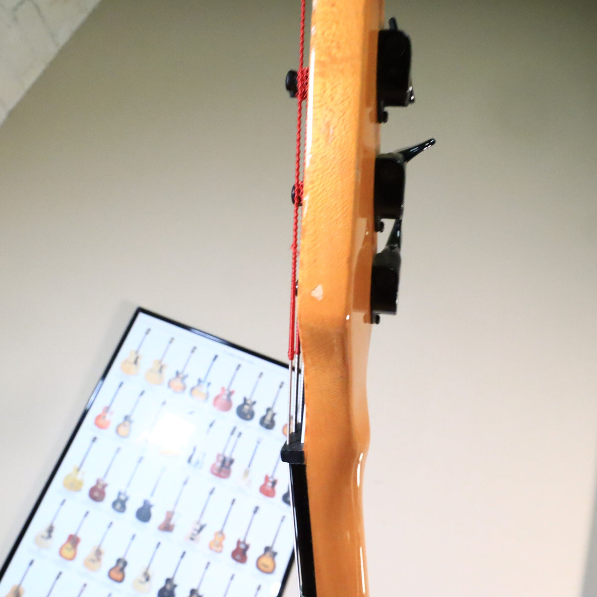 Side profile of the headstock showing a minor finish ding along the edge.