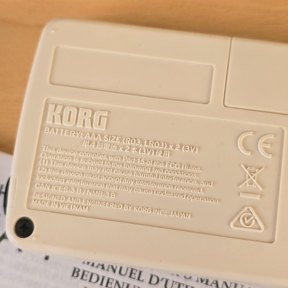 Macro close-up of the rear molded text on the Korg CA-1 tuner showing country of origin.