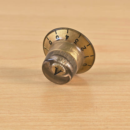 Side angle view showing profile of gold top hat control knob