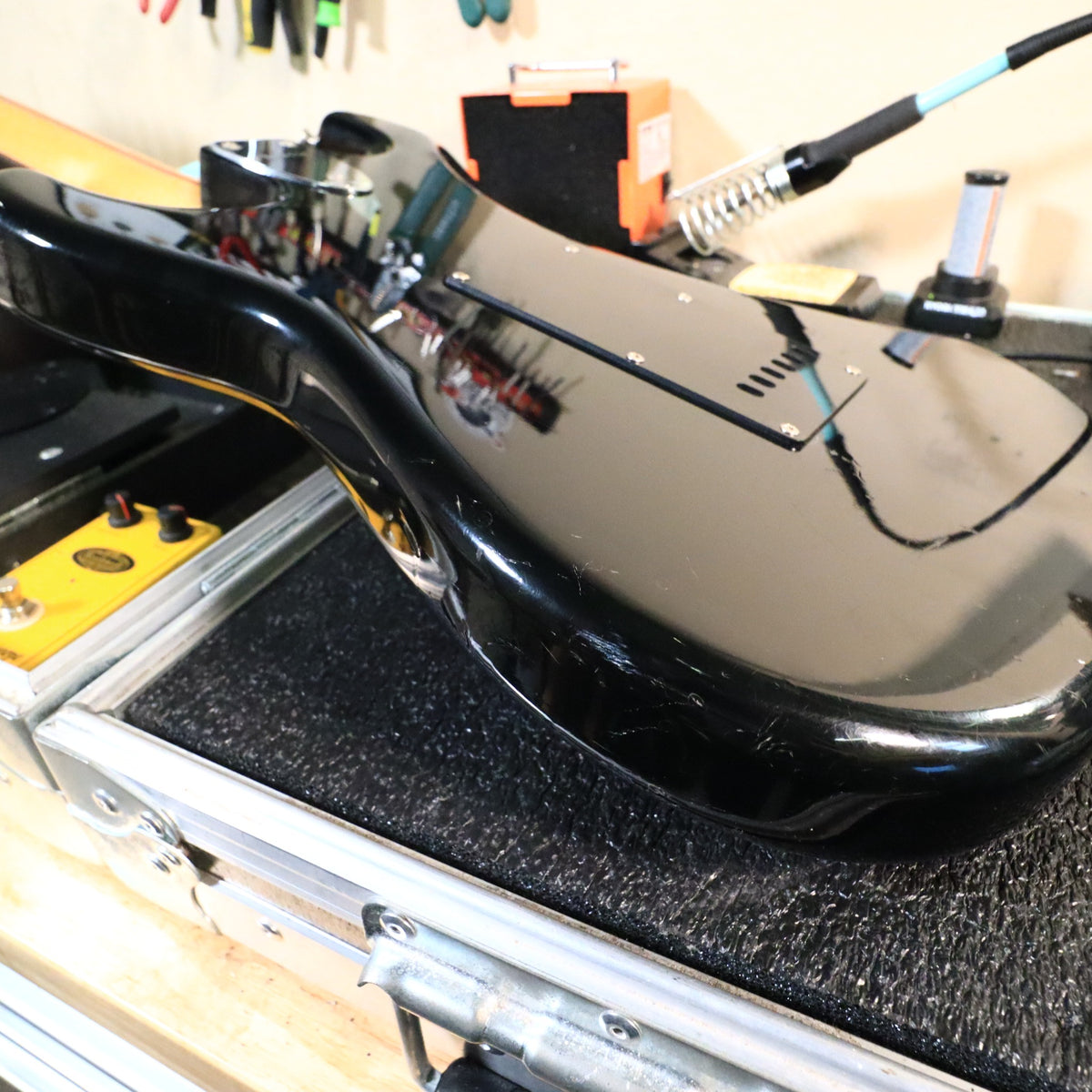 Close-up of lower body edge showing surface scratches and finish scuffs.