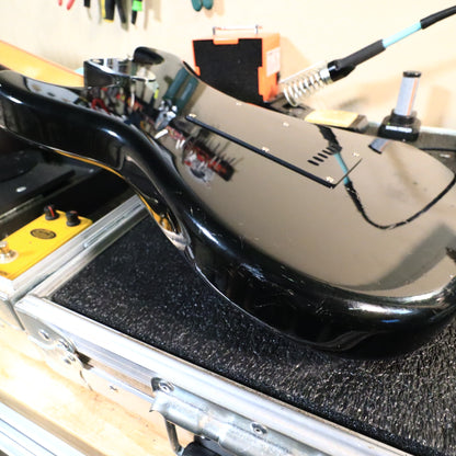 Close-up of lower body edge showing surface scratches and finish scuffs.