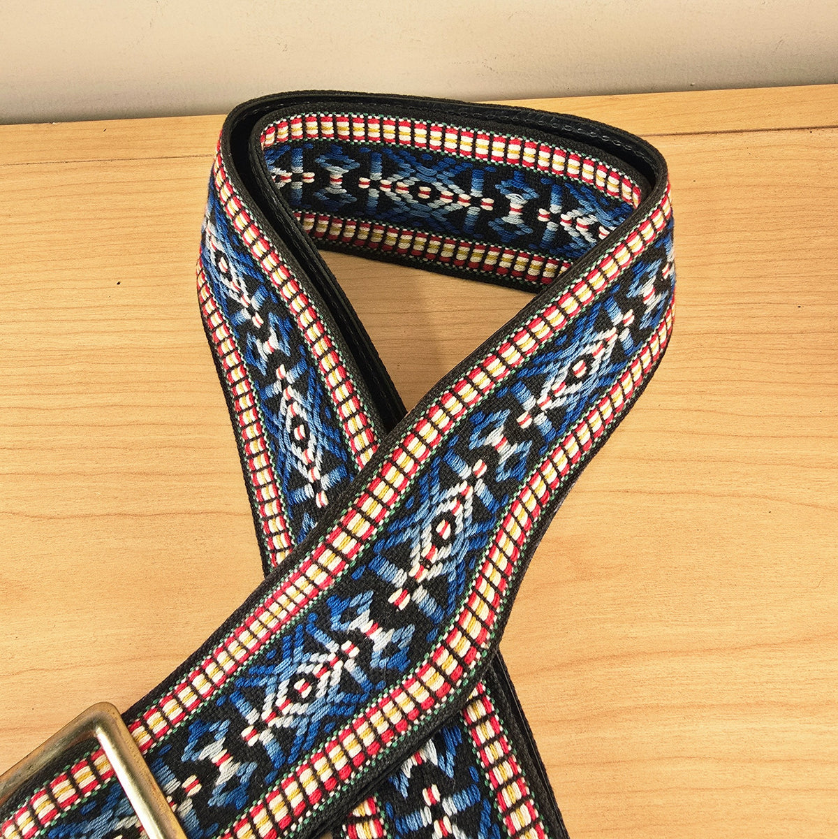 High-angle view of the folded woven guitar strap