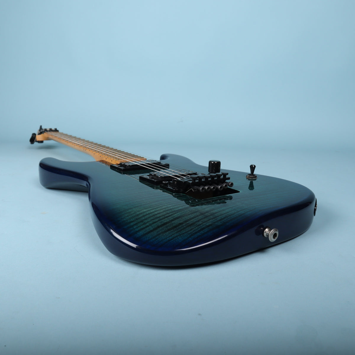 Angled side view of guitar body and controls