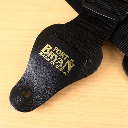 Close-up of black leather strap end with gold stamped Fort Bryan Made in USA logo.