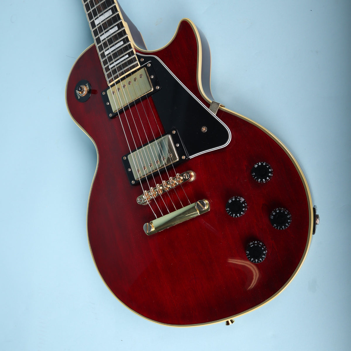 Angled perspective view of guitar body top and gold tailpiece