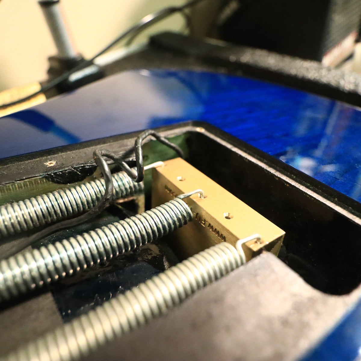 Low angle view of guitar body on workbench edge