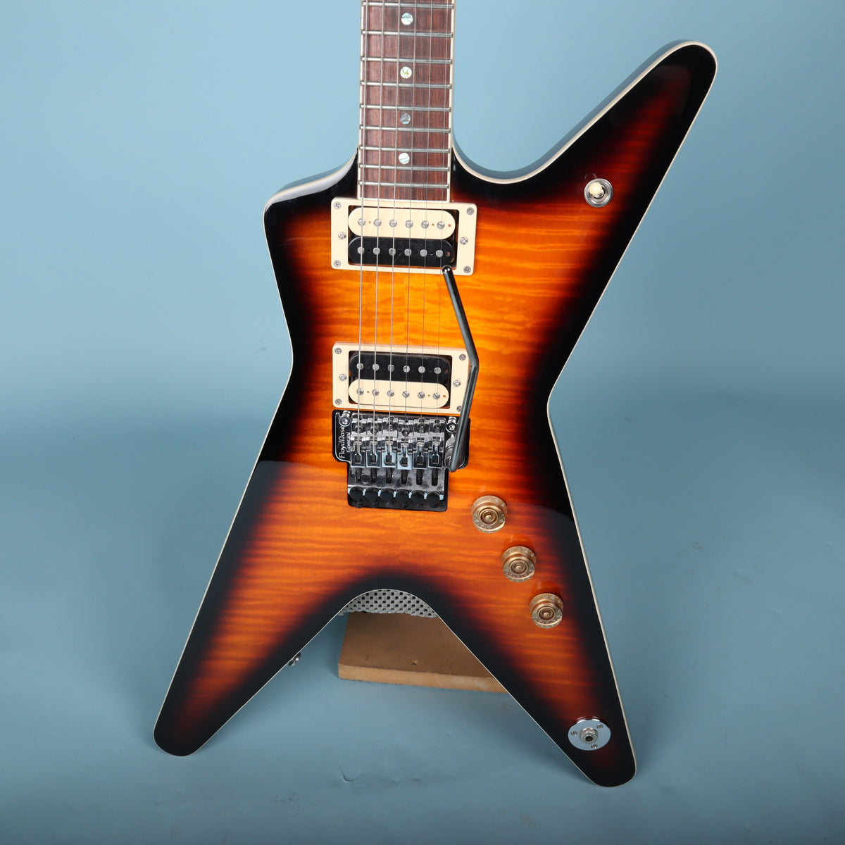 Close-up of Dean ML body showing dual zebra humbuckers, volume controls, and pickup switch