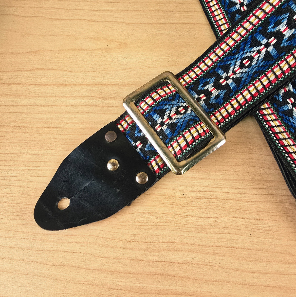 Close-up view of the metal adjustment buckle and woven strap pattern