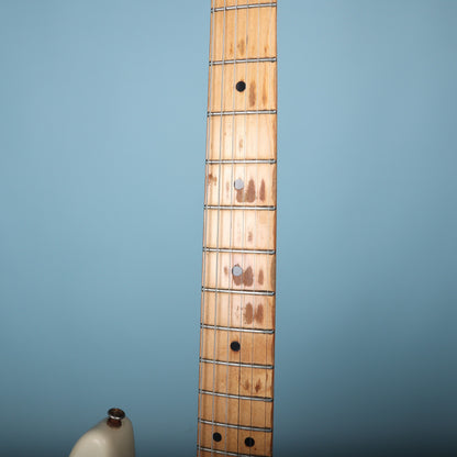 View of maple fretboard showing dot inlays and play wear patterns