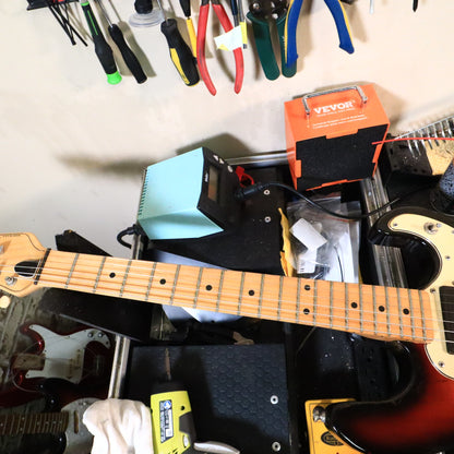 Overview of the neck and upper body on a workbench.