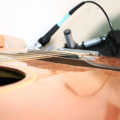 Profile view highlighting the low string action over the adjustable saddle on a Gibson 12-string.