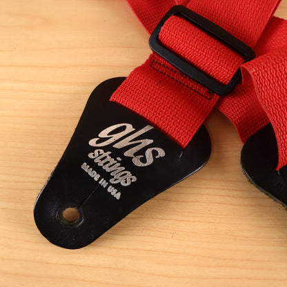 Close-up of GHS Strings Made in USA silver logo on black leather strap end.