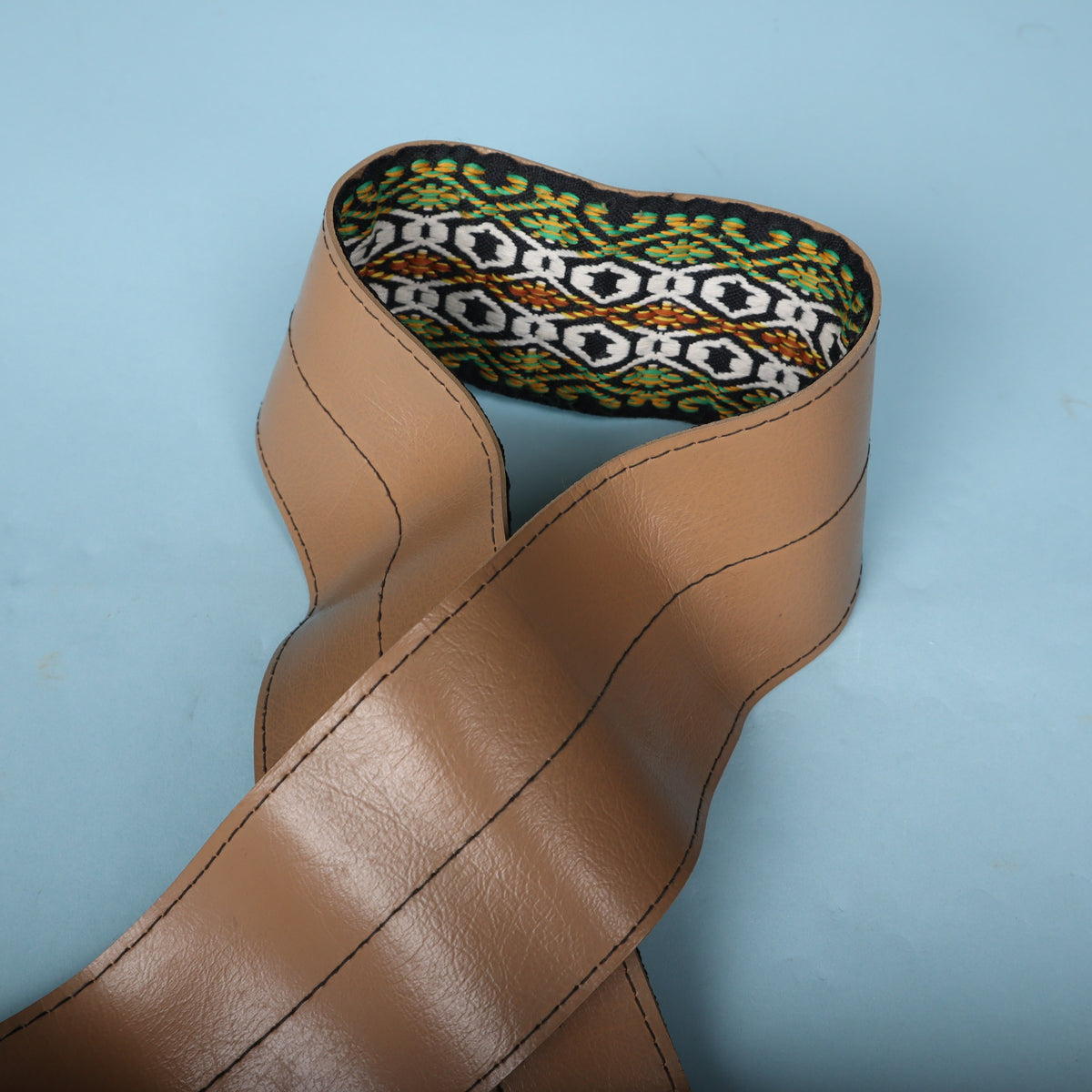 Folded view highlighting the transition from the tan vinyl backing to the woven top ribbon.