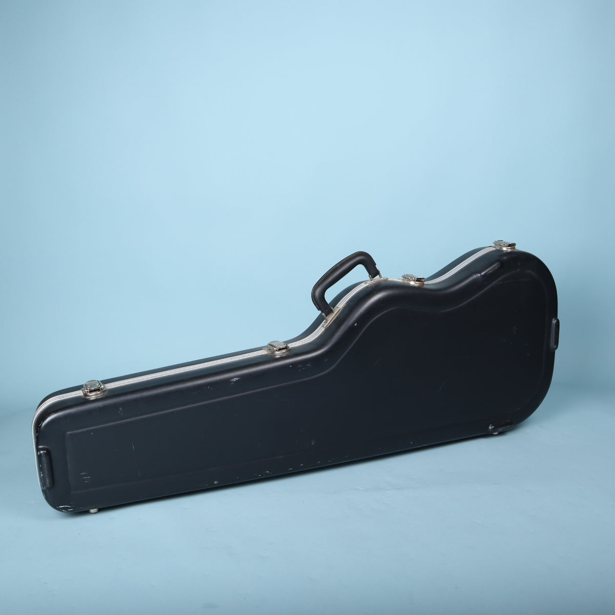 Back view of 2000s Fender molded hardshell case resting on bottom feet