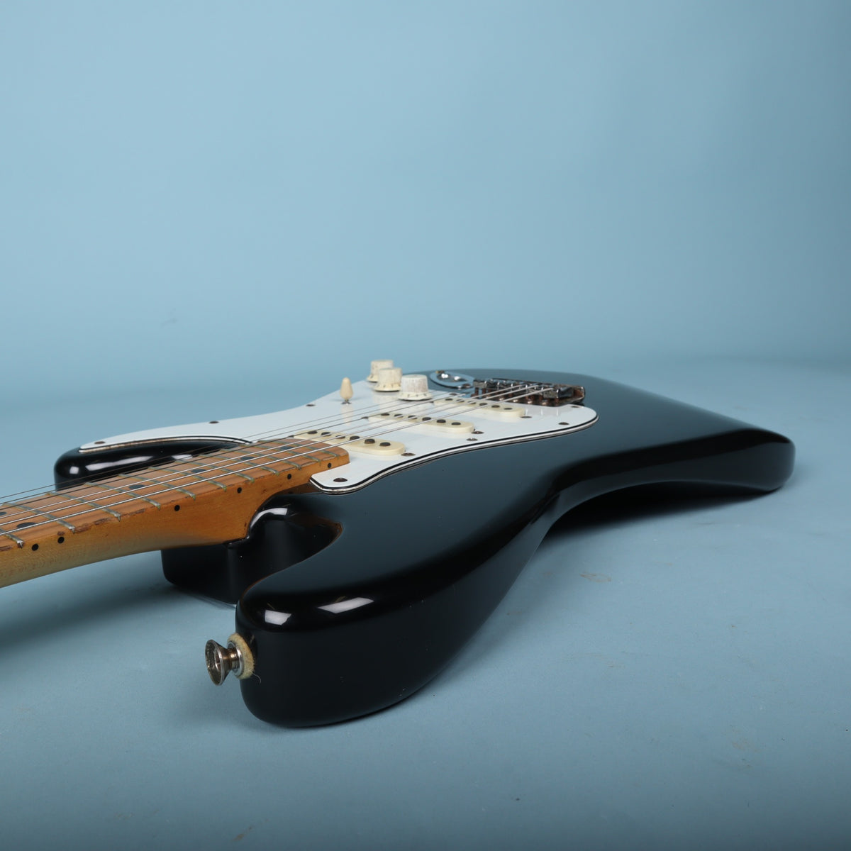 Angled side view of the guitar body and lower neck