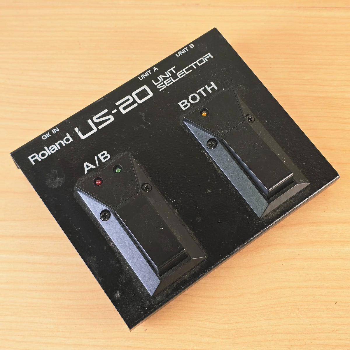 Top-down shot of the Roland US-20 pedal showing printed control labels and LEDs.