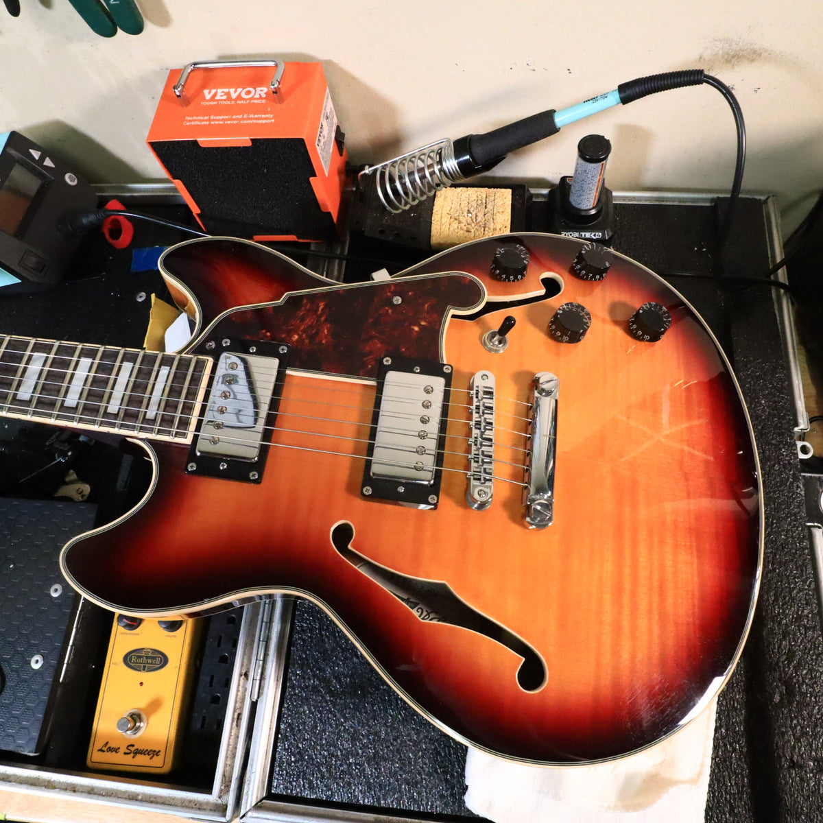 D'Angelico Premier Mini DC body resting on a workshop setup mat.