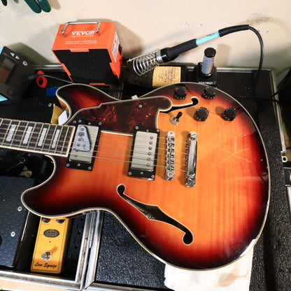 D'Angelico Premier Mini DC body resting on a workshop setup mat.