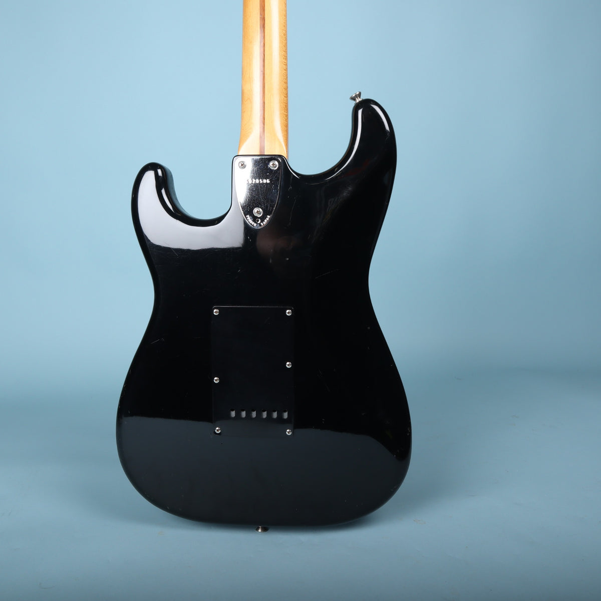 Full rear view of Squier Stratocaster guitar body showing neck plate and black backplate.