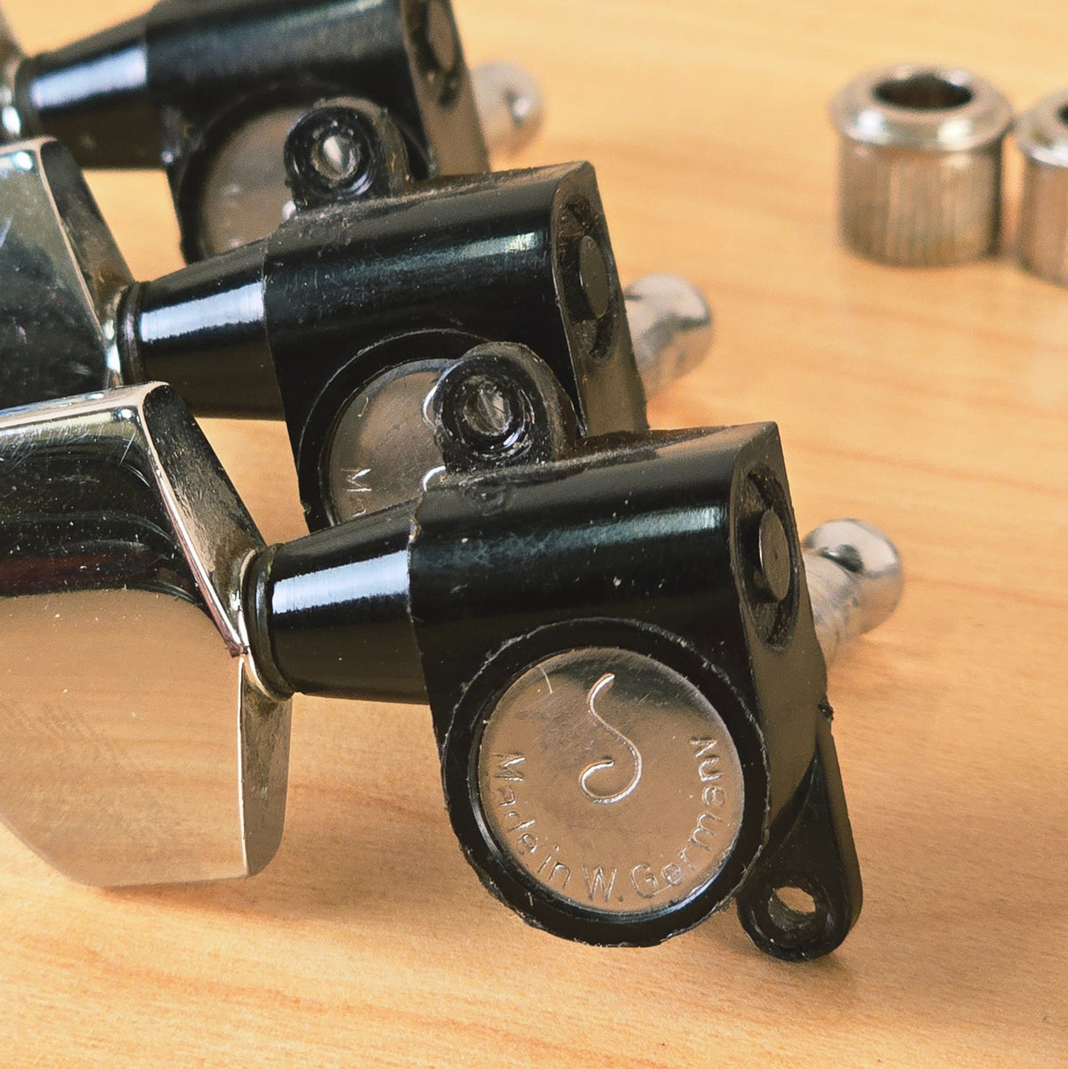 Close-up of Schaller S logo stamped on tuning machine housing back cover