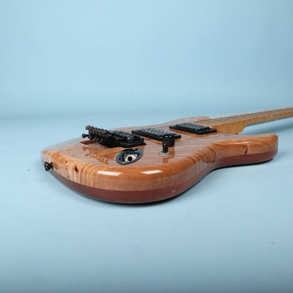 Side profile of guitar body showing laminated top and body woods.