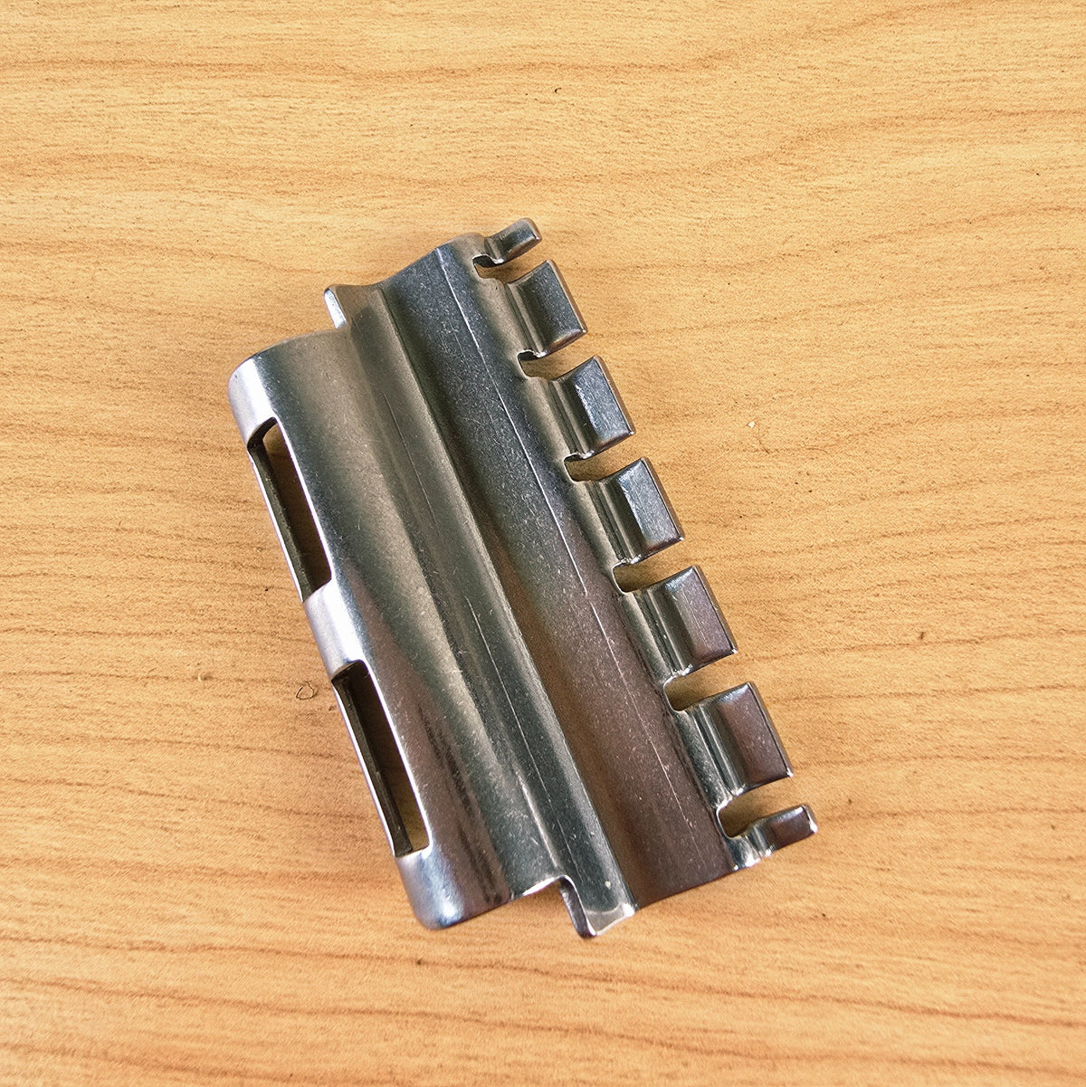 Underside view of the Vibramate Spoiler string retainer showing the string slots and mounting tabs.