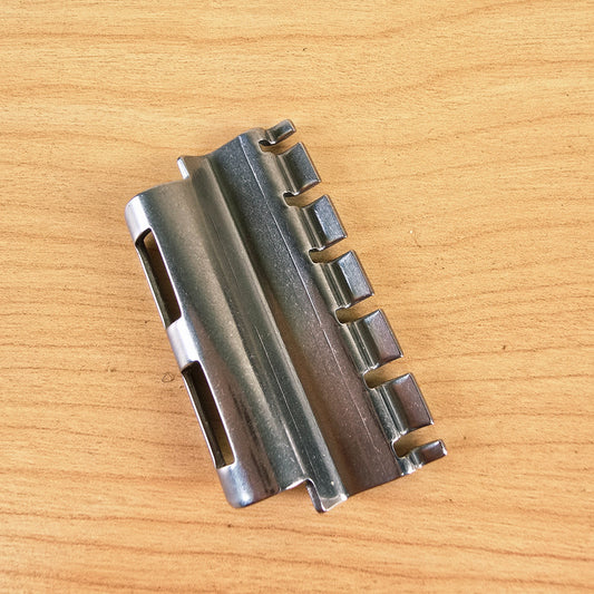 Underside view of the Vibramate Spoiler string retainer showing the string slots and mounting tabs.