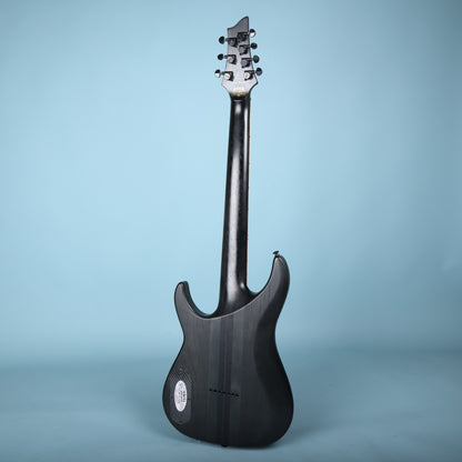 Full rear view of the Schecter KM-7 MK-II guitar against a blue backdrop