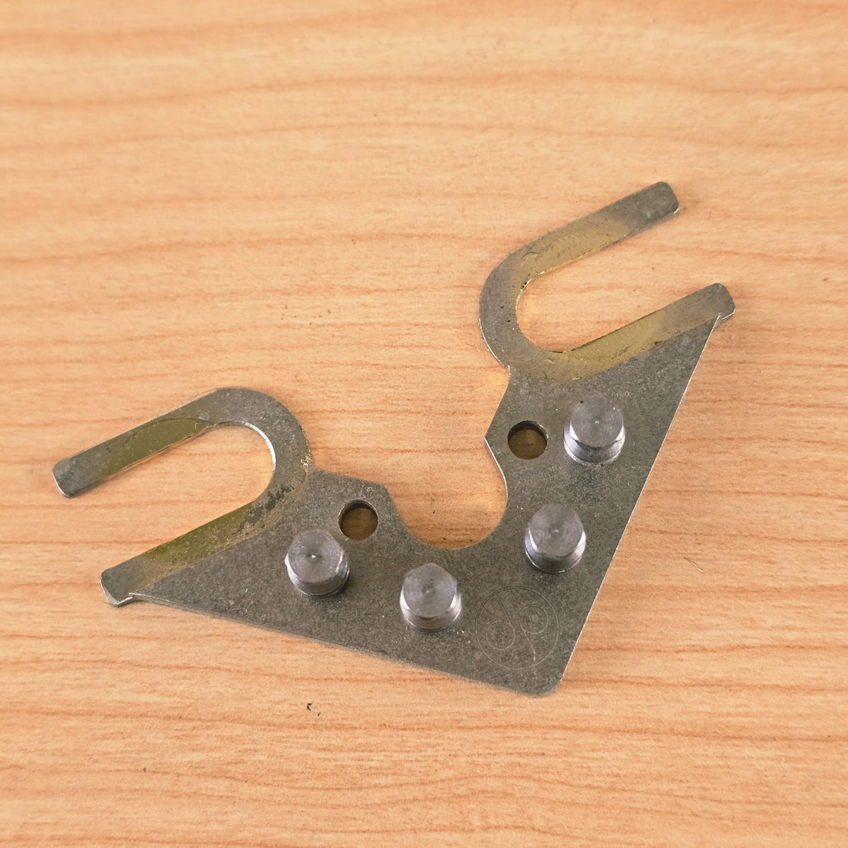 Overhead view of String Butler V3 resting on a natural wood surface