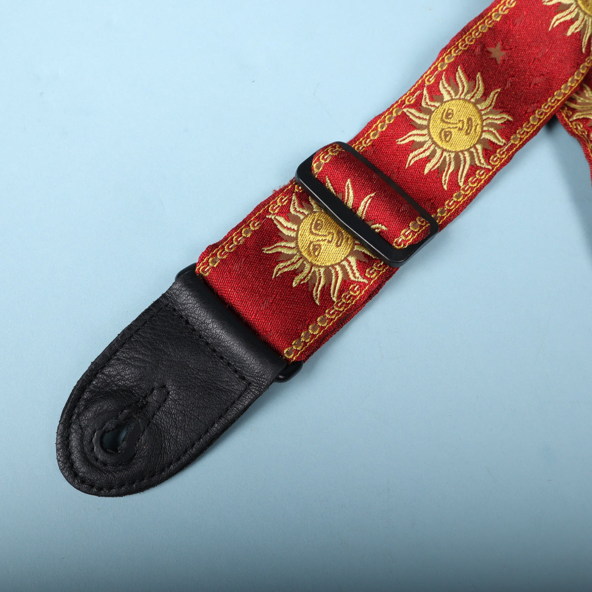 Black adjustment slider and end tab on the red jacquard strap