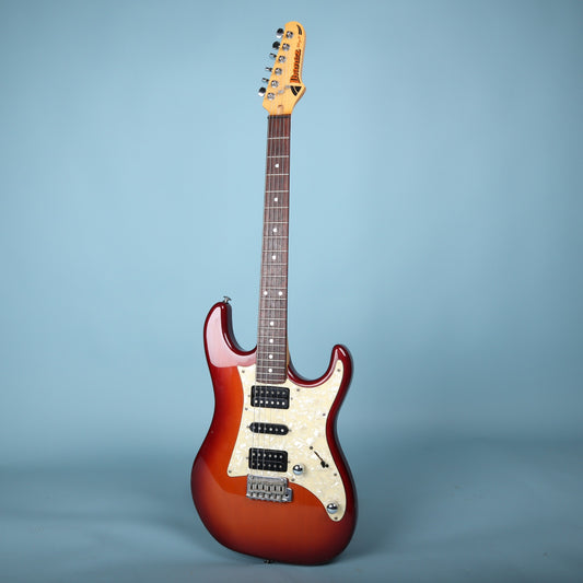 Full front view of Ibanez Blazer electric guitar in red sunburst with white pearloid pickguard.