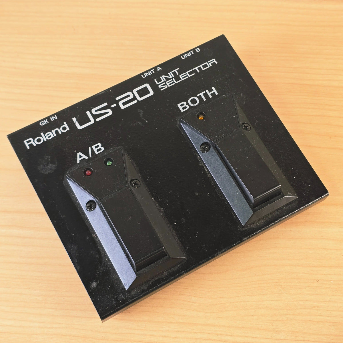 Overhead view of black Roland US-20 GK unit selector pedal with two footswitches.