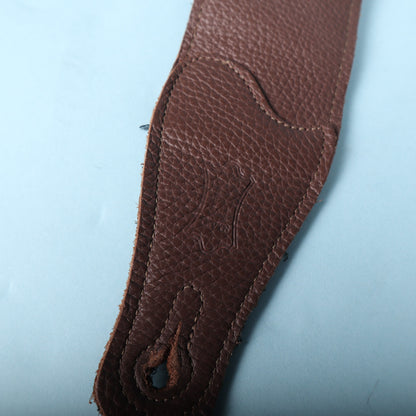 Close-up of the Levy's embossed logo and pin hole on the brown leather end tab