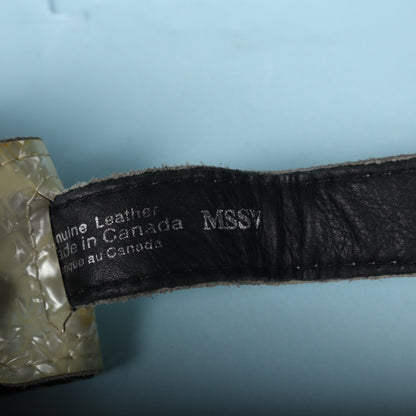 Macro shot of the silver stamped text reading Genuine Leather Made in Canada MSSV.