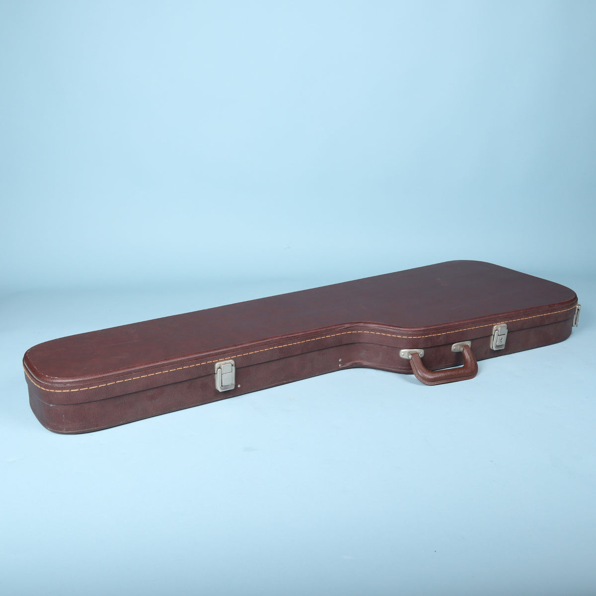 Side edge view of the closed Ibanez AH-10 guitar case highlighting the latches and stitching.