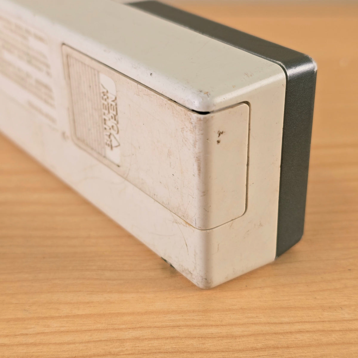 Close-up of the battery door and corner wear on the Boss TU-12H tuner.