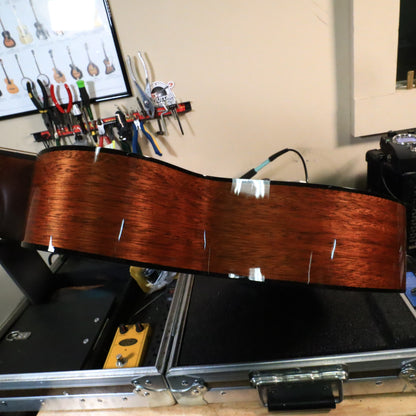 Side rim of the Martin 0-18 body inspected under workbench lighting.