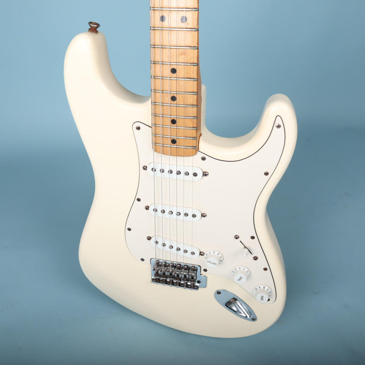 Angled body shot showing single-coil pickups and control knobs