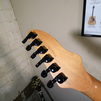 Angled close-up of the back headstock showing the stamped serial number