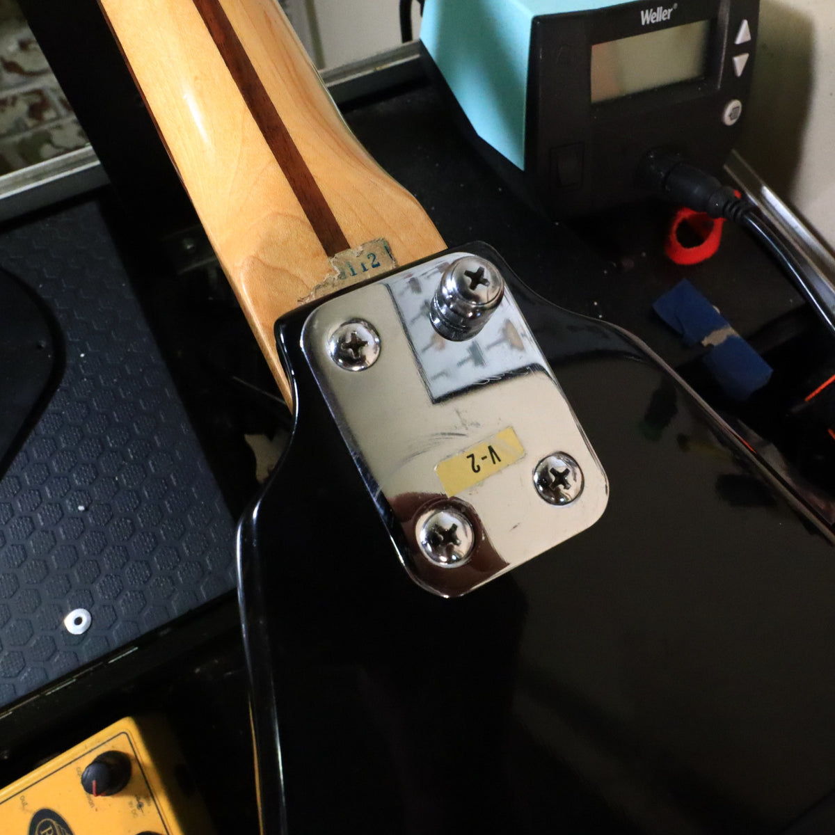 Chrome neck plate close-up displaying V-2 model label sticker.