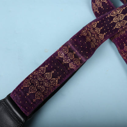 Macro detail of the purple crushed velvet fabric and gold metallic print