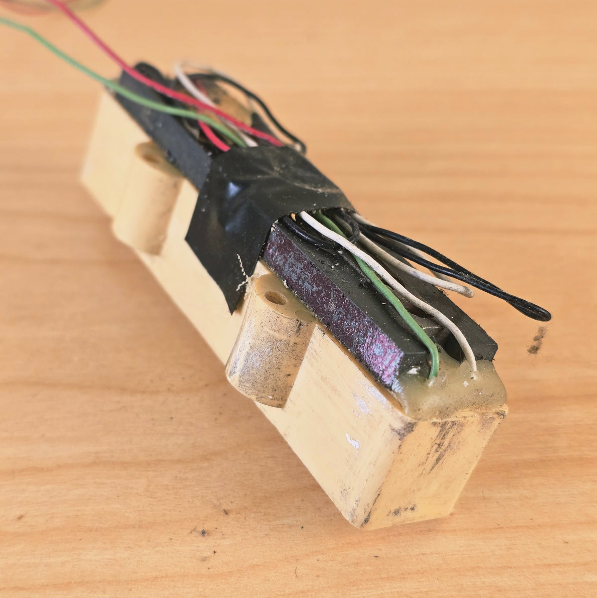 Bottom perspective view showing ceramic bar magnet and wiring layout on bass pickup.